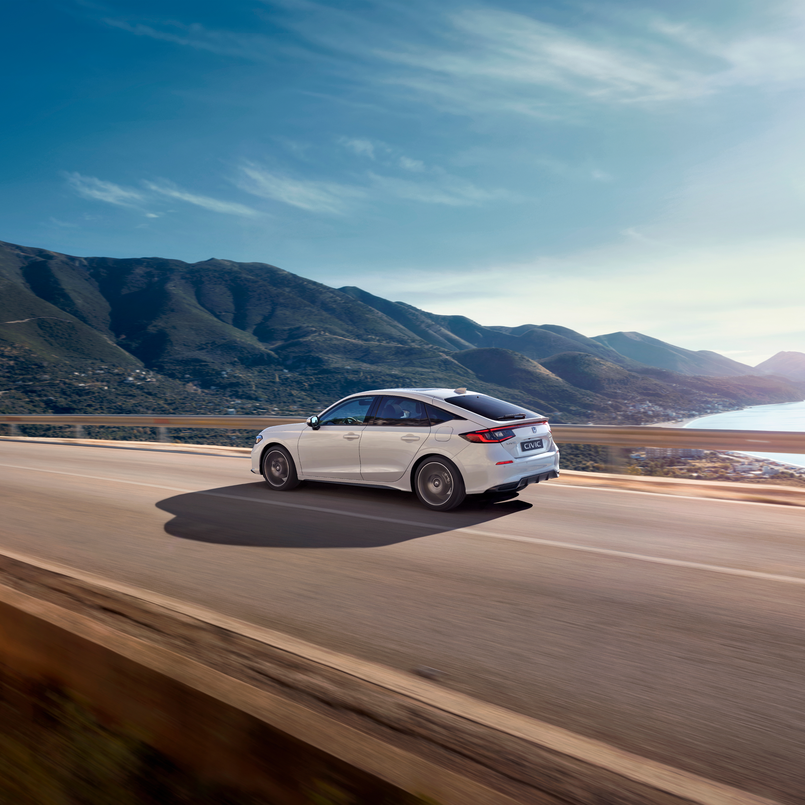 Honda Civic Hybrid driving on a highway, on a scenic route.